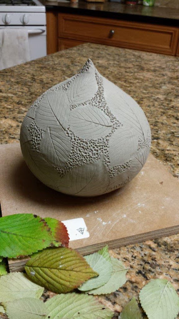 Ceramic pottery vessel with leaf imprints, in progress.