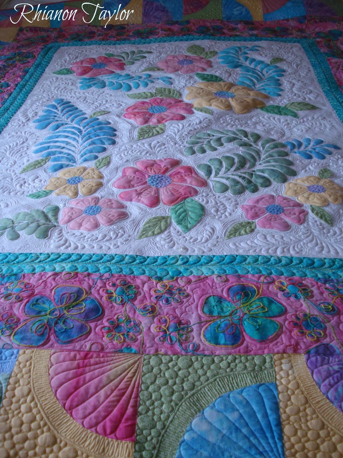 The Nifty Stitcher Fruit Salad Applique Quilt with flowers and feathers