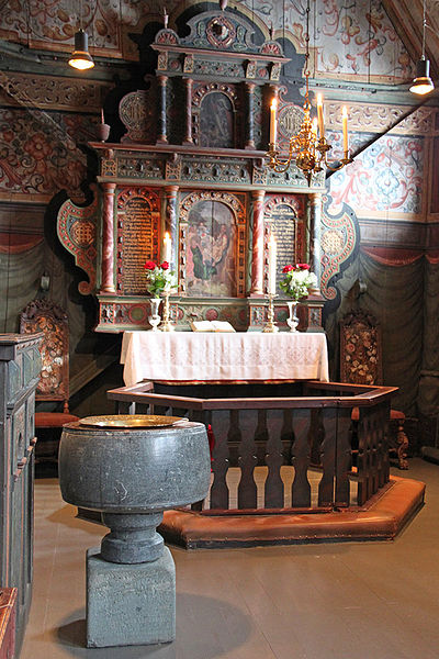 Interior view of the Røldal church shows the 13th-century Baptismal font.