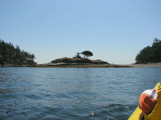 Upon leaving our seal friends, we paddled over to Bath and Saturnina Islands (three kayaks and people enjoying lunch on the tombolo)