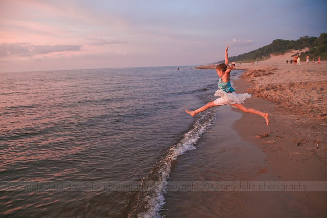 photo of a girl leaping into Lake Michigan at sunset