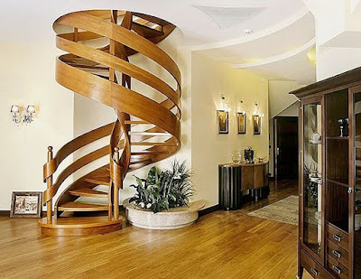 unique wooden curved stairs placed next to green plants