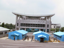 South Korean House of Freedom and blue armistice and military commission huts, DMZ from North Korea