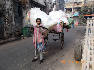 A Hand Rickshaw puller with his load of Cargo.