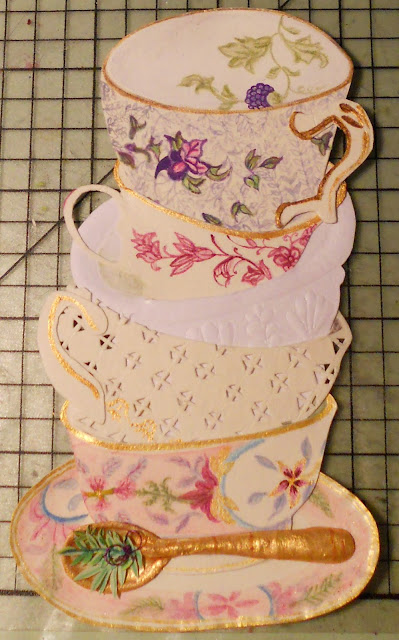 Hand made paper cut out tea cups, embossed and painted with acrylic and colouring pencils