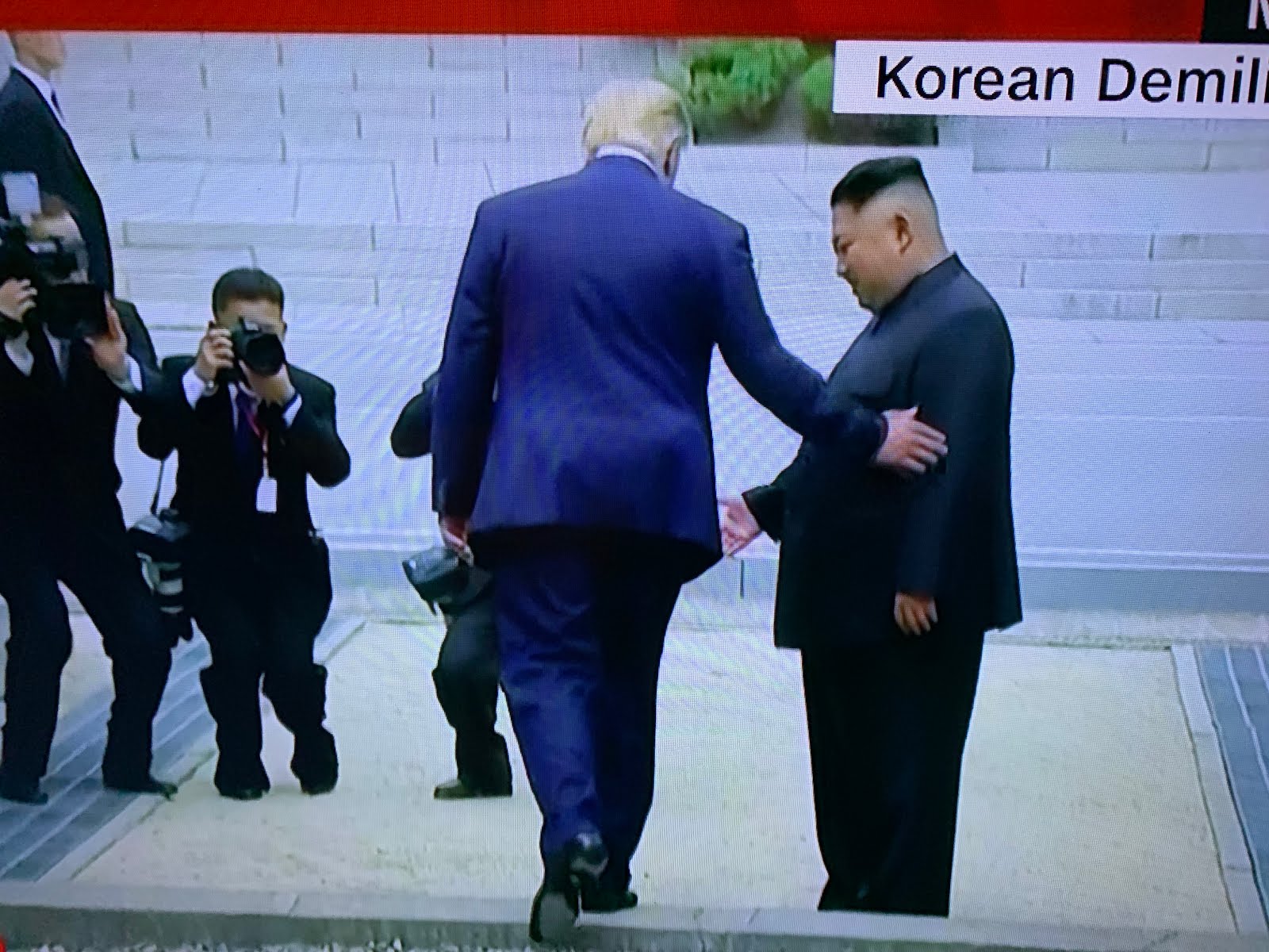 TRUMP STEPS INTO North Korea: WATCHED BY AN ADMIRING KIM.