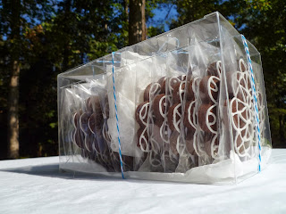crystal clear box of decorated dark-chocolate tea biscuits/cookies