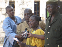Tostan Program Officer Penda Mbaye speaks about the significance of African Youth Day at celebration hosted at the Hann youth prison in Dakar.