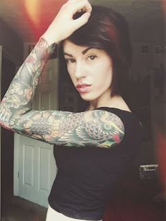 short haired brunette tattooed woman