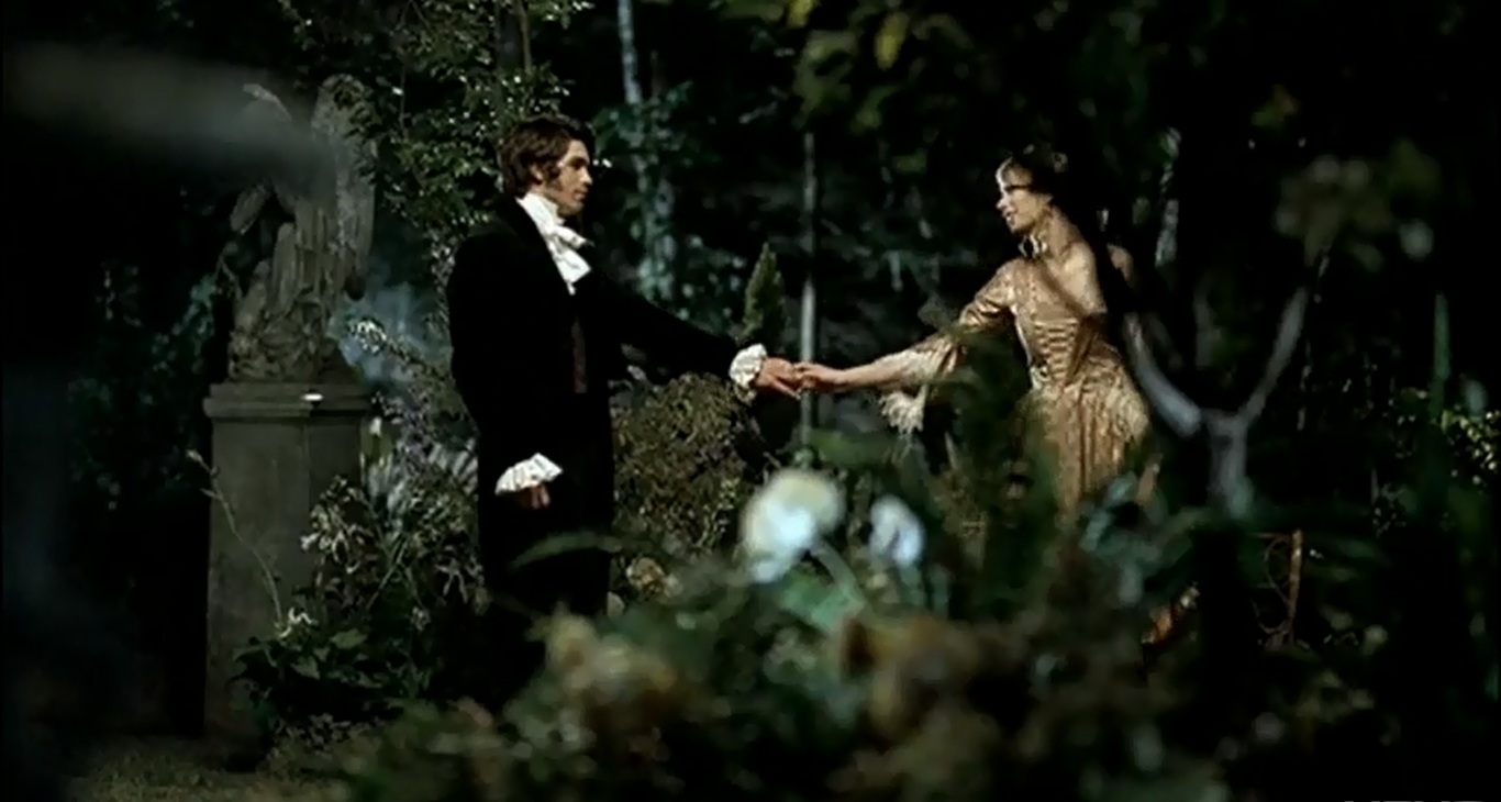 Romeo and Juliet meeting in the garden in music video for 