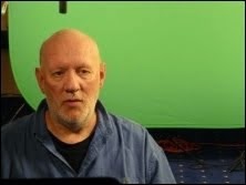 Brian Vike sitting in front of a green screen for the Discovery Channel TV UFO documentary.