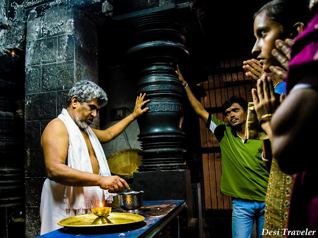 seeking blessings of priest at sacred center Hampi