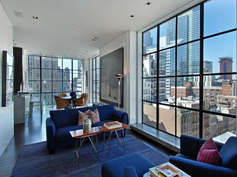 Photo of lovely living room with large windows in the Tribeca penthouse
