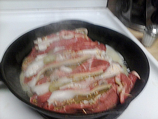 Frying the Beef stuffed with mustard pickles and bacon