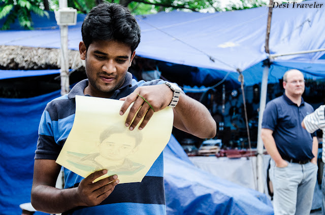 man looking at his portrait made at shilparamam