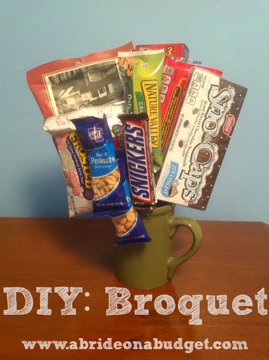 Candy sticking out of a cup with the words "DIY: Broquet" digitally written under it.