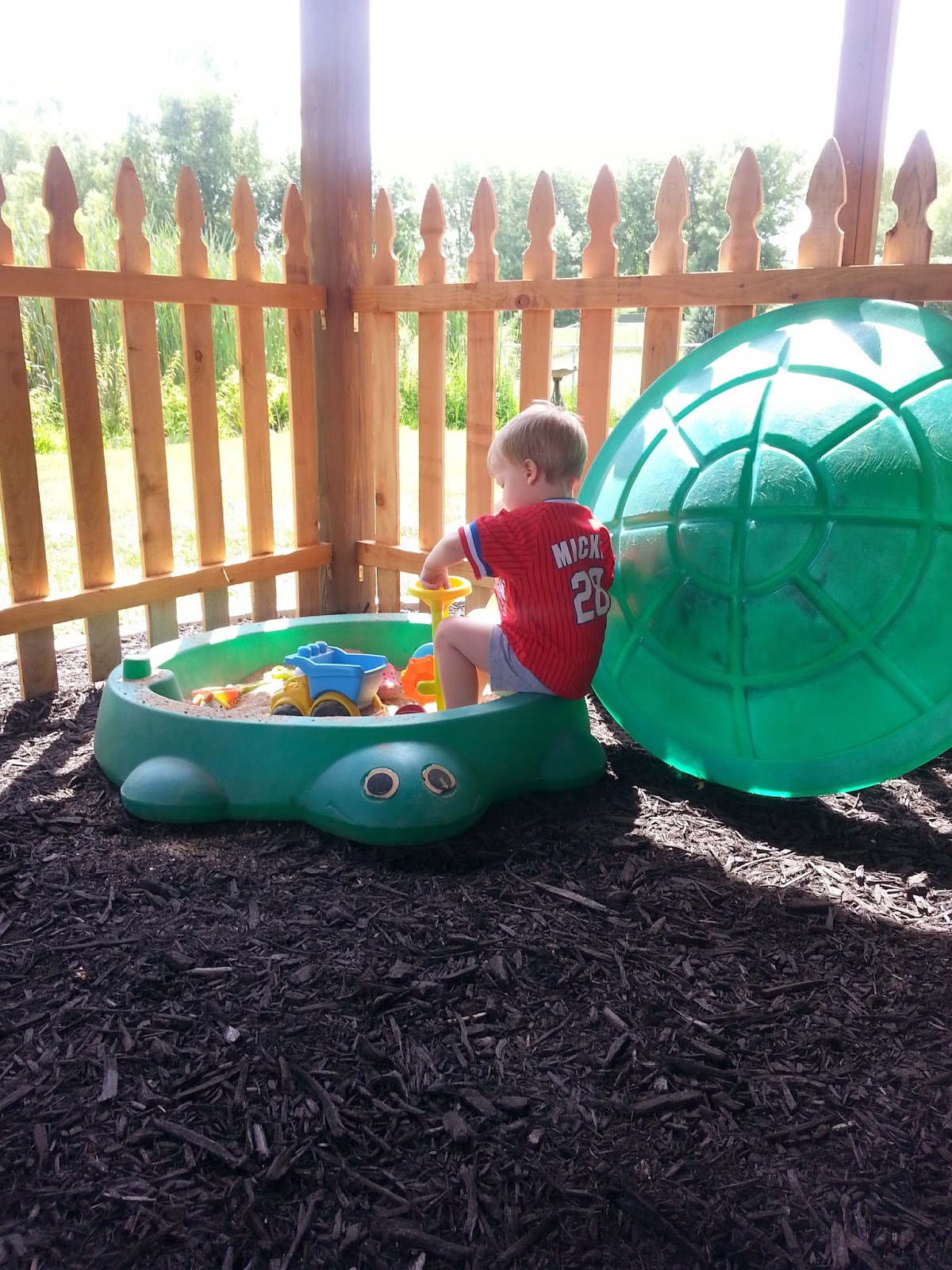 The Hotdish Mom Under Deck Landscaping and Fenced Kids Play Area