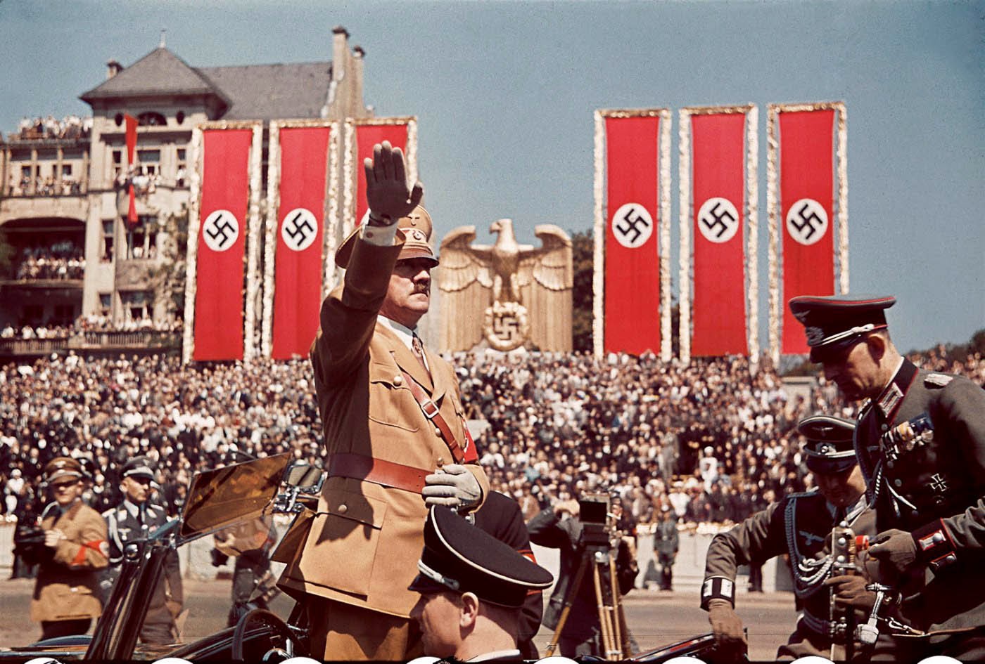 Adolf Hitler salutes troops of the Condor Legion who fought alongside Spanish Nationalists in the Spanish Civil War, during a rally upon their return to Germany, 1939.