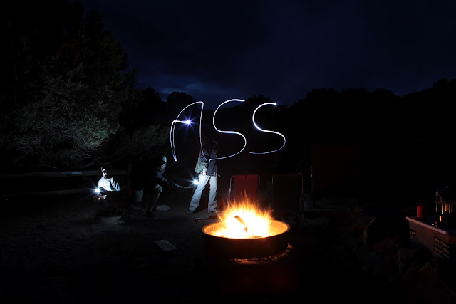 Light painting 'Ass' over a camp fire while National Park camping at the Sand Dunes.
