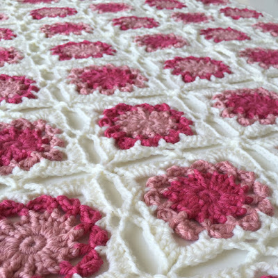 http://www.ravelry.com/patterns/library/bed-of-flowers-baby-blanket