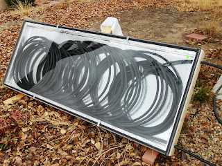 black tubing encased in a glass covered frame