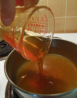 Cup of Honey being Poured into Saucepan