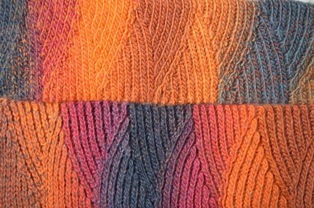 Close-up of slip stitch scarf in "Vesuvius" colours (oranges, reds and charcoal greys).