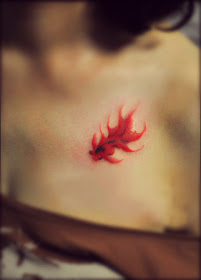 red goldfish tattoo on the chest