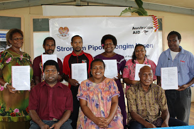 Representatives from the six community based organisation proudly display their Funding Deed with SPSN Field Program Coordinator Sabi Pati(front left) and representatives from the provincial government in Kiunga.