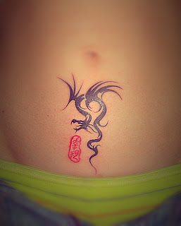 A small cute tribal type dragon tattoo on the hip