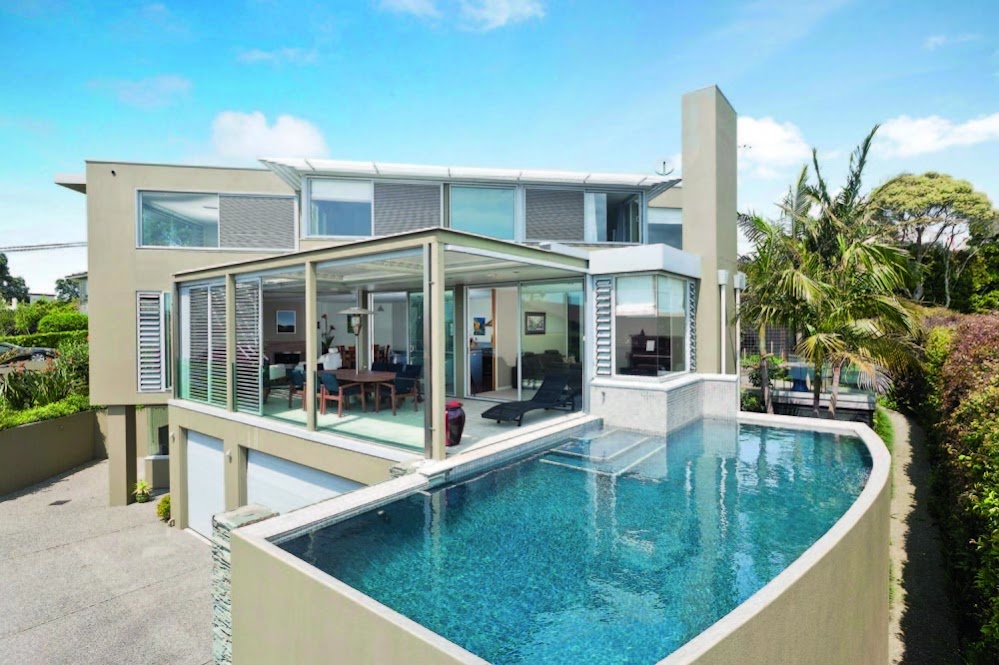 Photo of an amazing modern house as seen from the pool side