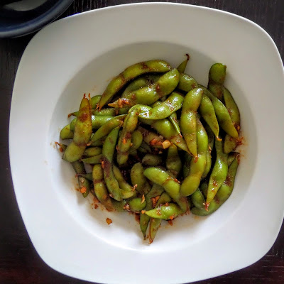 Spicy Edamame:  Young soybeans, in the pod, sauteed in ginger, garlic, soy sauce, and sriracha.  A spicy, salty, and nutritious snack.