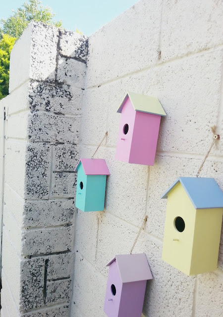 painting birdhouses to brighten up the garden