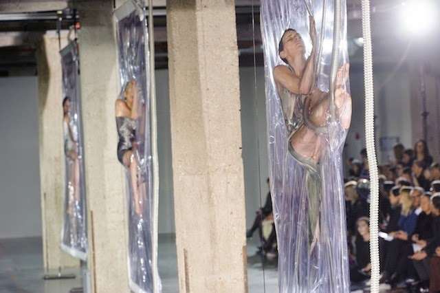 Iris van Herpen runway show with a backdrop of models 