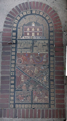 Bricks, brass and stone art marking the Boston Latin School location