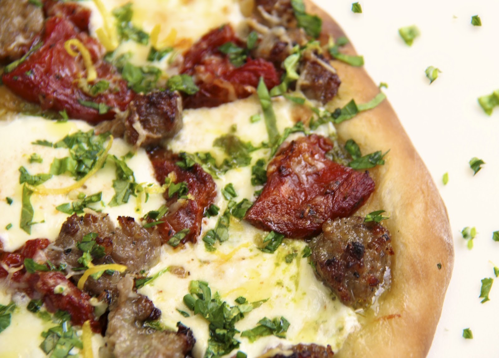 Pesto Pizza w/ Italian Sausage, SlowRoasted Tomatoes & Spring Herb