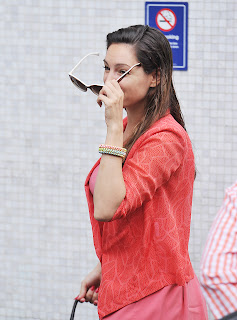 Kelly Brook putting her sunglasses on 