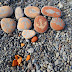 art on the beach with painted stones