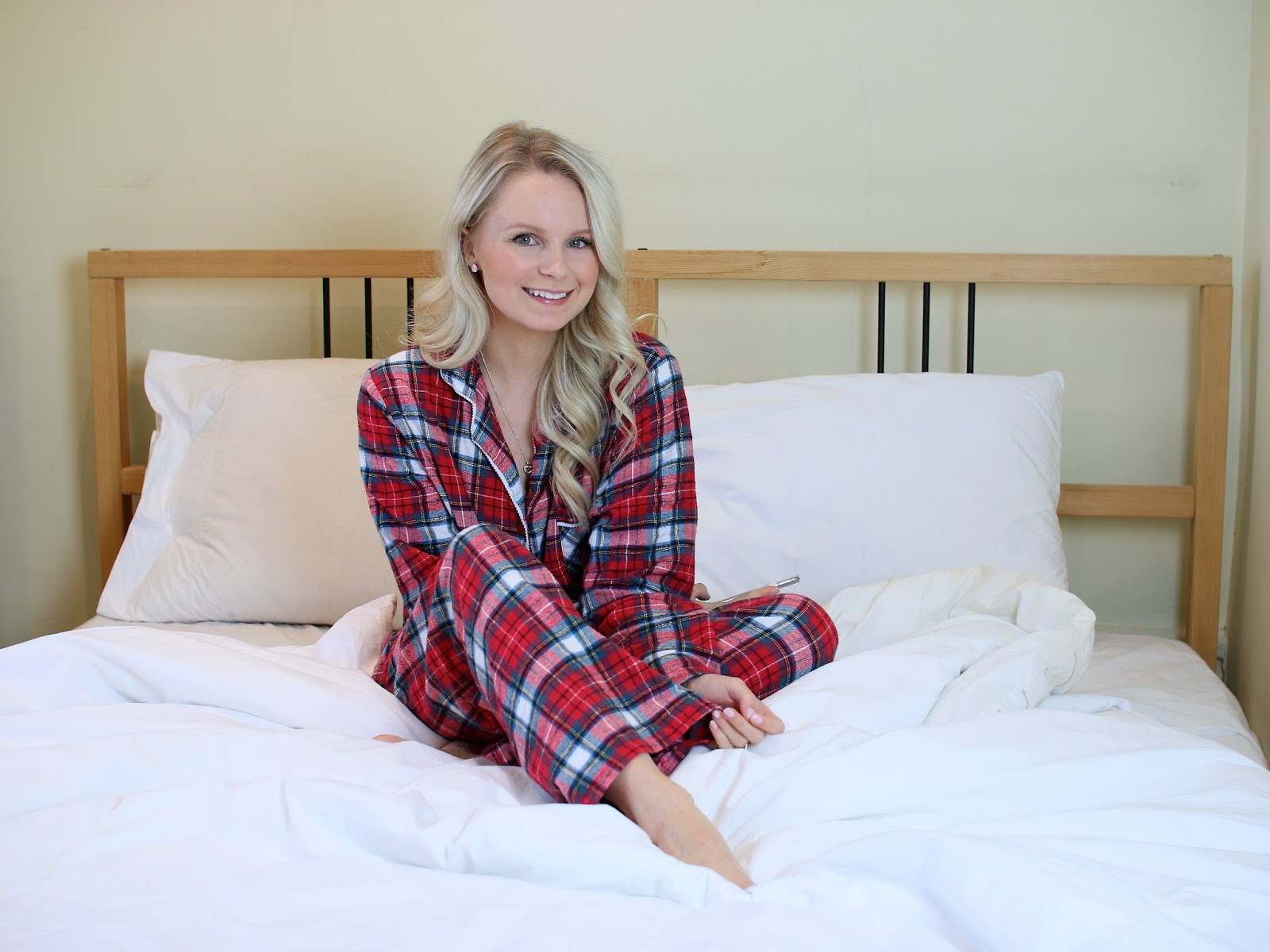 a women sitting on a bed in oversized sleep wear for christmas 