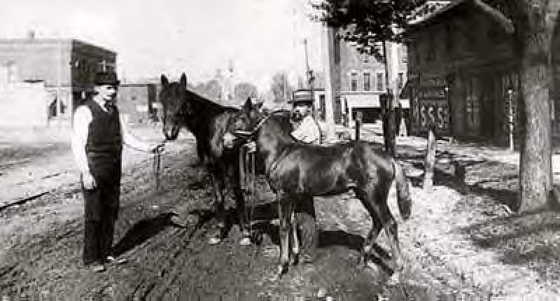 Clark's Tavern is to the right in the photo. The two men (and the horses) are unidenified ~