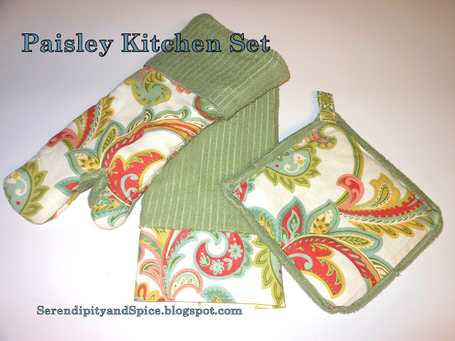 blog+051 Paisley Kitchen Towel Ooooh, I feel like Spring is almost here!</p> Don't you feel it?!</p>  
I love the warmer weather, the sunny days, the April showers, the May flowers, yard sale finds, flea market browsing, craft fair inspirations, oh the list goes onand on!</p> This fabric makes me think Spring!</p> This kitchen towel was super easy and super cheap to make!  I used a bar mop towel from the Dollar Tree and some leftover fabric from my Paisley Oven Mitt. For some crazy reason I didn't take pictures of the process but... All you do is cut about 6 inches of fabric.  Measure the width to fit the towel, leaving about 1/2 inch on each end for the hem.  Just hem each edge and the bottom of the fabric strip.  Then attach to the end of the towel.  I added the fabric embellishment to both ends of the towel. That's it!  Easy Peasy!! Don't you just LOVE this set!
