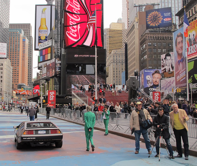 The Electric DeLorean enters Times Square filmed by the film crew producing