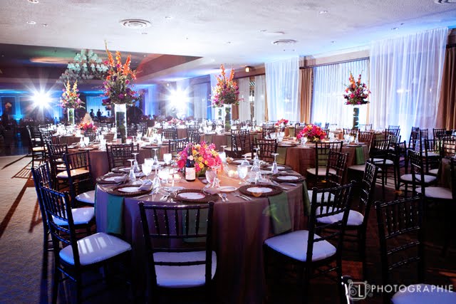 The tall centerpieces were a leafwrapped cylinder with a tropical flower 