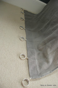 spacing out curtain rings with clips along a sheer drape