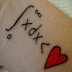 Math formula and red heart tattoo on wrist