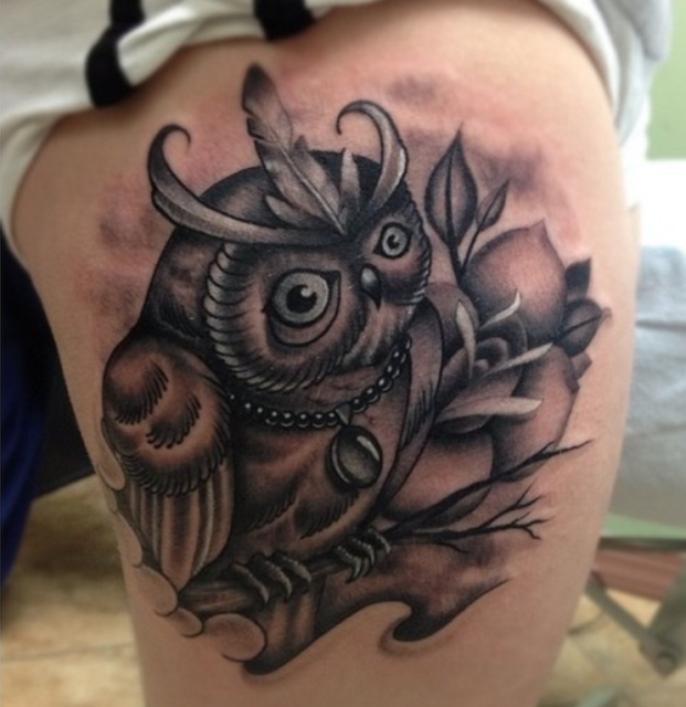 Angry black owl tattoo on side body