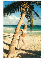 Doutzen Kroes standing below a palm tree