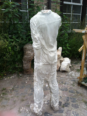 a headless white sculpture 