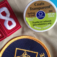 Use clear thread to sew scout patches onto uniforms