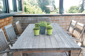 Teak dining table and chairs for outdoor dining, perfect with the natural green accents